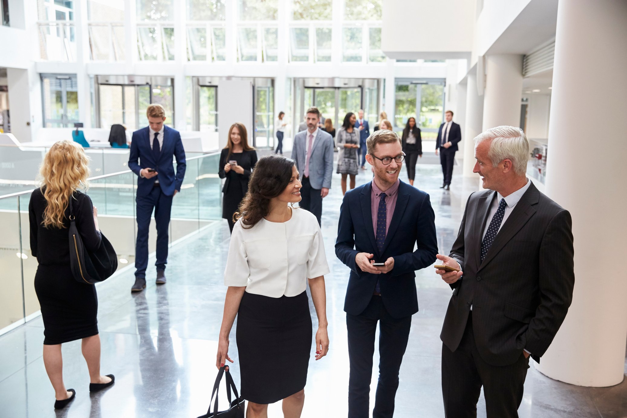 Businesspeople in Busy Lobby Area of Modern Office